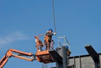 Belgrade, Serbia - February 27, 2016: Construction worker on a raised platform puts the reinforcement of the pillars of the building