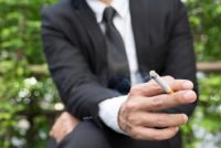 Businessman Smoking Outside Facility