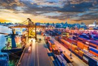 Container Cargo freight ship with working crane bridge in shipyard