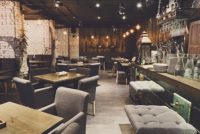 Interior of cozy restaurant. Contemporary design in loft style, modern dining place and bar counter, copy space