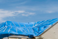 Tarp covering damaged roof