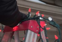 Christmas lights resting on metal ladder