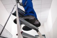 Person standing on ladder