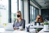 Workers in facility with masks and proper distancing
